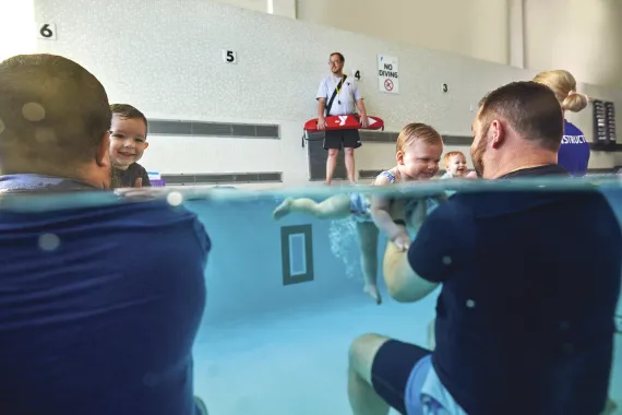 Swim volunteer teaching kids.