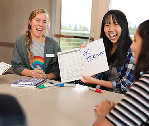 young adults at a table working on a project