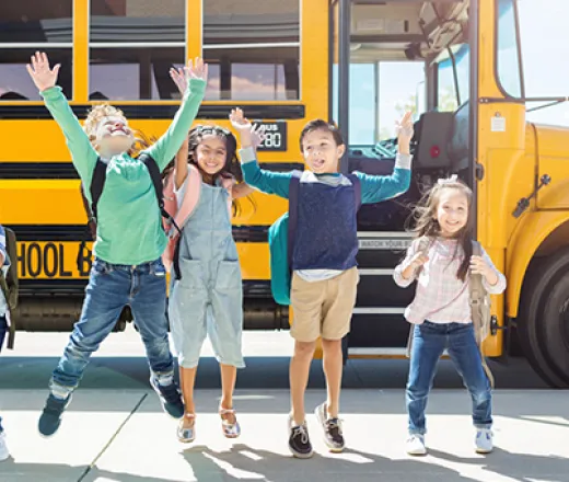 kids jumping in front of bus