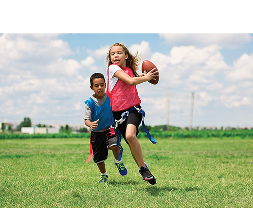 Girl and boy playing flag football