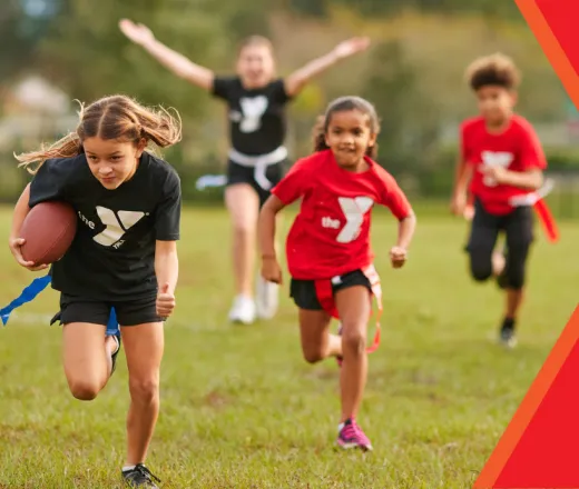 children running on a field playing flag football