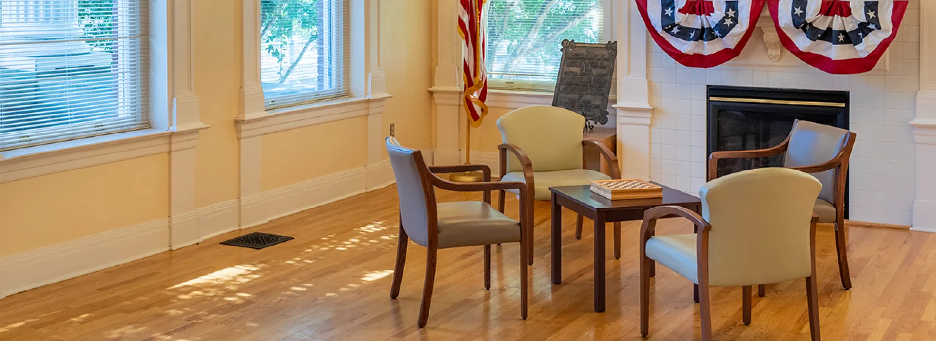 Chairs around a table and a fireplace