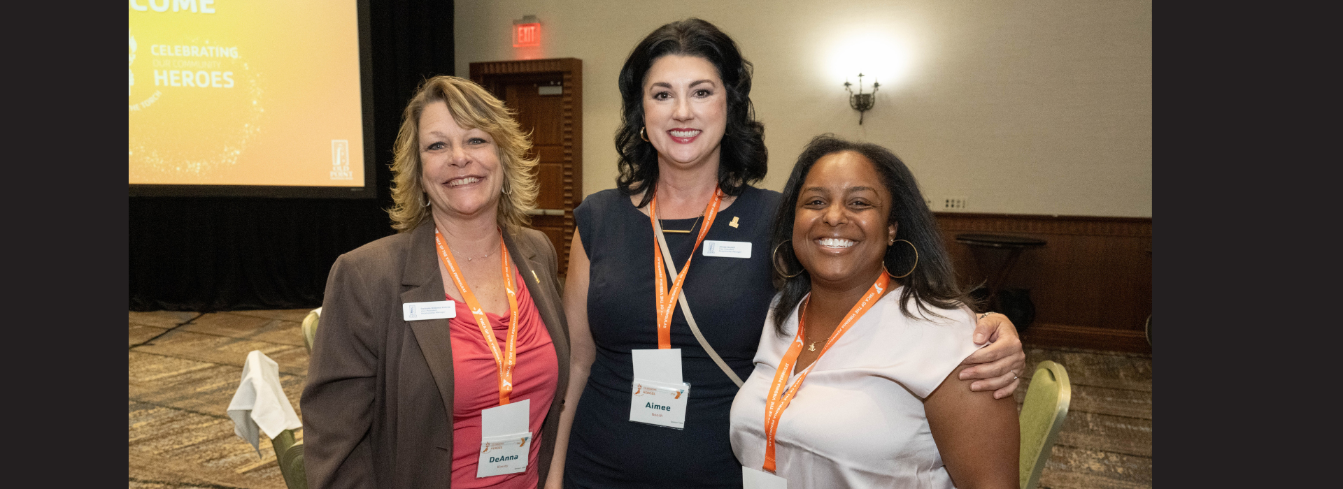 Three people smiling.